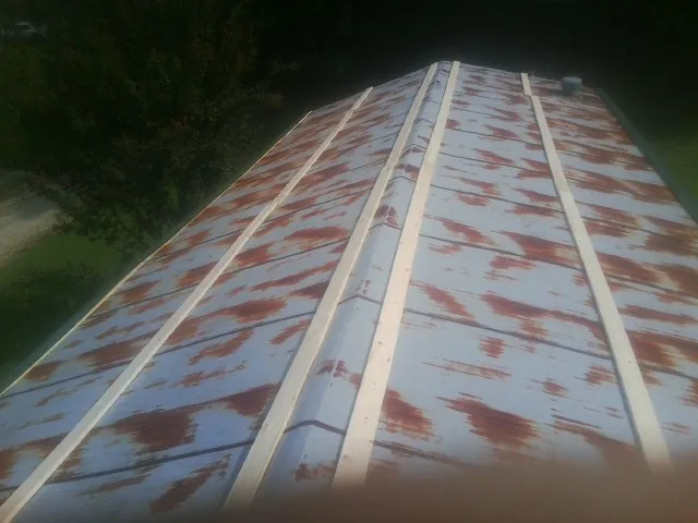 Rusted metal roof panels with new wood purlins before replacement — Storm Damage Roof Repair in Finleyville by Roofing Brothers
