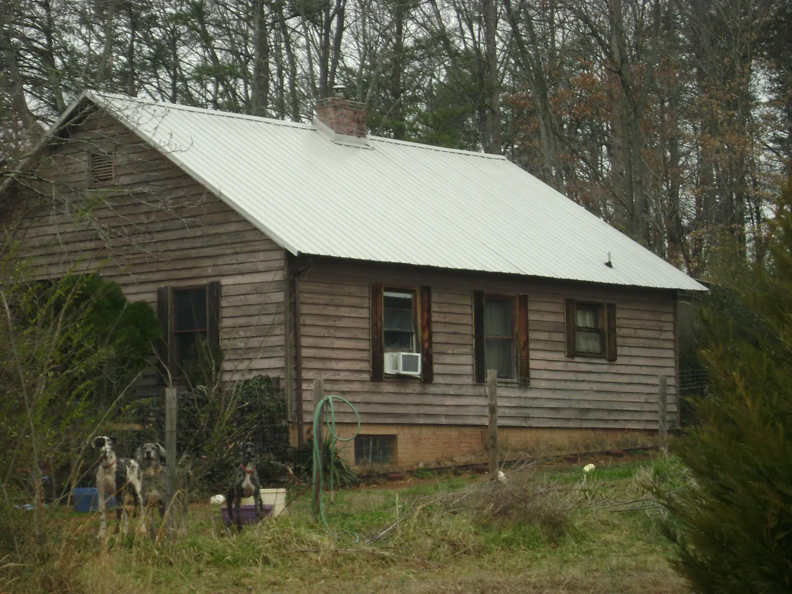 White metal roof on an old wood sided farmhouse, from a Metal Roof Installation job in Finleyville